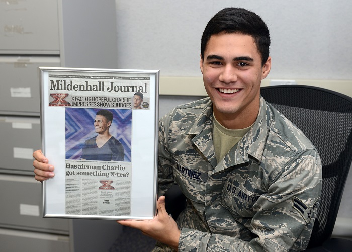 U.S. Air Force Airman 1st Class Charlie Martinez, 100th Force Support Squadron force management apprentice from Orlando, Fla.,
poses for a photograph with a newspaper clipping of himself Oct. 15, 2014, on RAF Mildenhall, England.
The clipping was from Martinez's time on X Factor United Kingdom, a televised British singing competition.